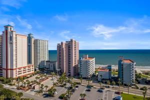 a city with tall buildings next to the ocean at The Beverley Beach House in Myrtle Beach