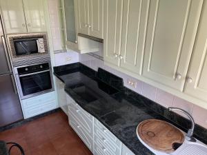 a kitchen with white cabinets and a sink at Casa Tía Blanca in Valverde +3 photos