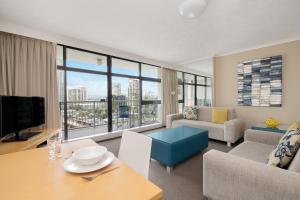 a living room with a view of a city at BreakFree Beachpoint in Gold Coast