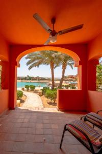 an orange room with a ceiling fan and a patio at VESTA - El Gouna Residence in Hurghada