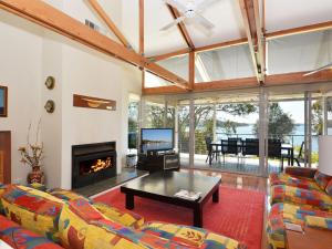 a living room with a couch and a fireplace at Morisset Bay Waterfront Views House in Morisset East