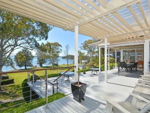 an outdoor deck with a view of the water at Morisset Bay Waterfront Views House in Morisset East