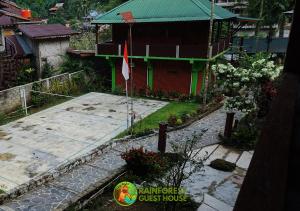 an aerial view of a house with a flag at Rain Forest Guest House in Bukit Lawang