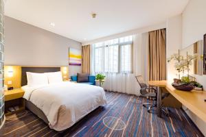 a hotel room with a bed and a desk at Holiday Inn Express Shijiazhuang Heping, an IHG Hotel in Shijiazhuang