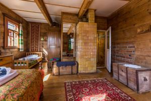 a bedroom with two beds and a brick wall at MorzeLas Chata Białowieża in Białowieża