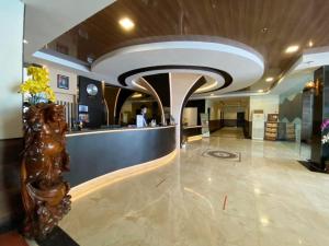 a lobby with a bar in the middle of a building at Batam Harbour Boutique Hotel & Spa in Nagoya