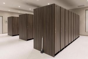 a row of wooden partition walls in a room at TUBE Sq in Tokoname