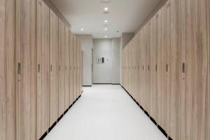 a hallway with wooden lockers in a gym at TUBE Sq in Tokoname