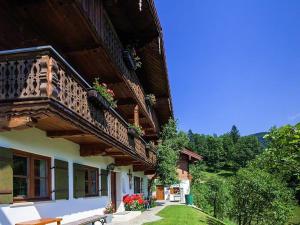 a building with a balcony with flowers on it at Ferienwohnung Leitenlehen in Berchtesgaden