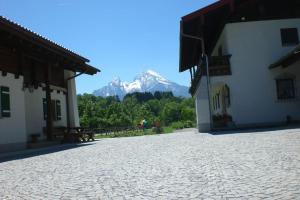 un patio de piedra con una montaña en el fondo en Kilianhof, en Berchtesgaden 4 fotos más