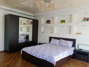 a bedroom with a bed and a chandelier at 1-room Studio center in Cherkasy