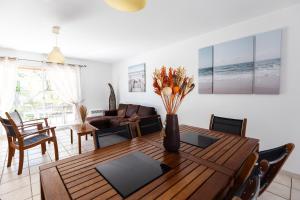 a living room with a wooden table and a couch at Paradiles in Dolus-d'Oléron