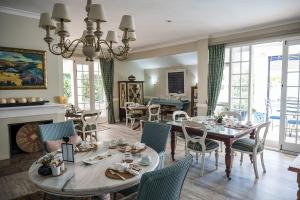 a dining room with a table and chairs at Admiralty Beach House in Port Elizabeth