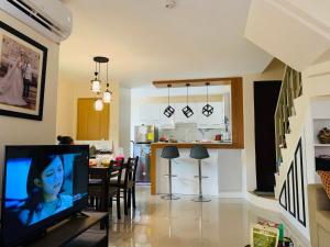 a living room with a television and a dining room at Mansfield w Parking - Fully airconditioned in Angeles