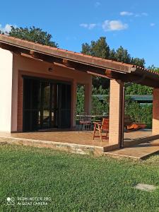 a pavilion with a table and chairs on a patio at Agriturismo Oasi del Pianettino in Campagnatico