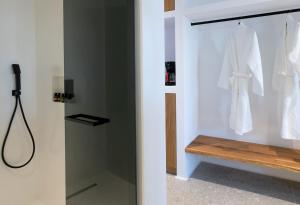 a bathroom with a shower and a glass door at Agrari Bo Suites in Agrari