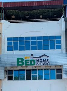 a building with a bed home stay sign on it at MyBed Homestay in Padang Besar