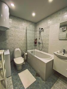 a bathroom with a tub and a toilet and a sink at Apartment 31 Vila Golf Nice Vacation in Rogaška Slatina