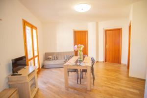 a living room with a table and a couch at Valery Apartments Alghero in Alghero