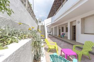 un patio con sedie colorate e scale in un edificio di Gallipoli a due passi Residence a Marina di Mancaversa