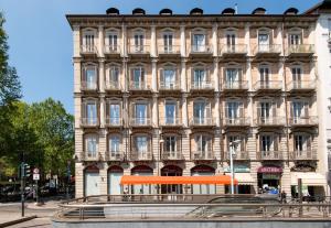 a large building with an orange sign in front of it at Il Gioiellino in Turin