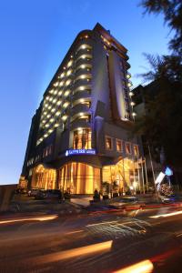 a large building with lights on the side of a street at Sapphire Addis in Addis Ababa