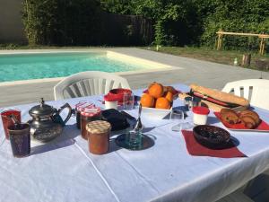 a table with a blue table cloth with food on it at Le Teich Tranquille in Le Teich