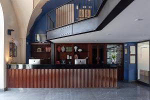 a lobby with a bar in a building at Coclee Suite Palace in Salve