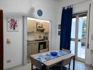 a kitchen with a table with a blue bowl on it at Rose Apartment in Gaeta