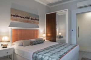 a bedroom with a bed and a painting on the wall at Delight Deluxe Aparts in Antalya