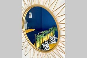 a mirror reflection of a bedroom in a blue room at Stylish, cosy studio in Carmarthen town centre in Carmarthen