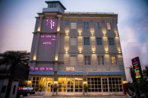 a building with a clock tower on top of it at Regenta Inn Amristar Airport Road by Royal Orchid Hotels Limited in Amritsar