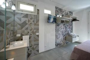a bathroom with a sink and a shower at ITACA e MEDEA - Appartamenti con idromassaggio in terrazza in San Vito lo Capo +28 photos