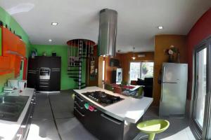 a kitchen with green walls and a stove top oven at House'n'Kite in Nurachi