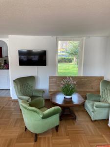 a living room with two chairs and a table at Haus Berlin in Hagen