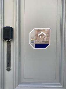 a door with a house sign on it at Brussels Guest House in Brussels