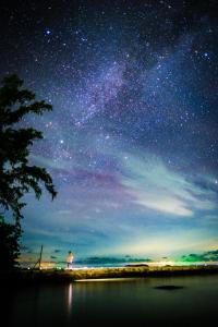 a person standing on a beach under a starry sky at Cay Sao Resort in Phú Quốc