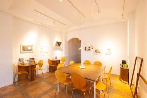 a dining room with a wooden table and chairs at OwlStay The Salt in Hualien City