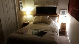 a bedroom with a bed with a book on it at Garragh Mhor in Oban