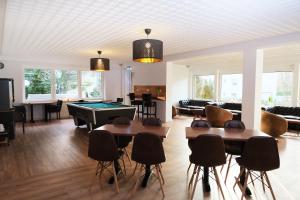 a living room with a pool table and ping pong ball at Forest Rooms in Bad Bevensen