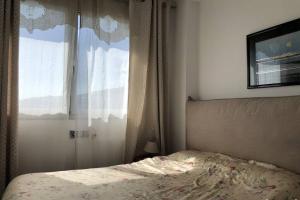 a bedroom with a bed and a window at NEREIDES 31 in Platja d'Aro