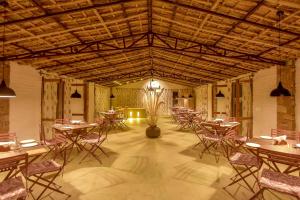 a large room with tables and chairs in it at Camp Lands End in Pushkar