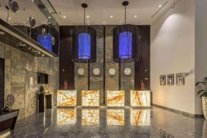 a lobby with a wall with clocks on it at The First Collection Dubai Marina in Dubai