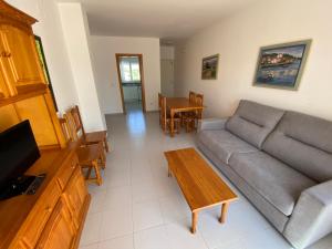 a living room with a couch and a table at Apartamentos Serenamar Altamar in Alcossebre