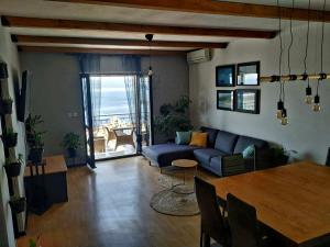 a living room with a blue couch and a table at Apartments Asija in Brela