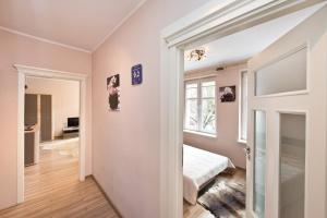 a bedroom with a door open to a room with a bed at Gdańskie Apartamenty - Old Town Rooms & Apartments in Gdańsk