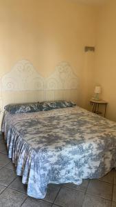 a bedroom with a large bed with a large headboard at agriturismo la selva in Finale Ligure