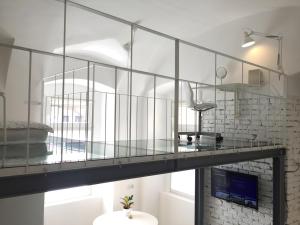 a glass bridge in a room with a table at Micro Loft Central in Unirii in Cluj-Napoca +22 photos