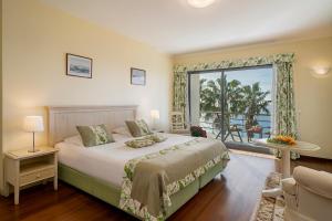 sypialnia z łóżkiem i dużym oknem w obiekcie Casa do Papagaio Verde w Funchal +32 zdjęcia