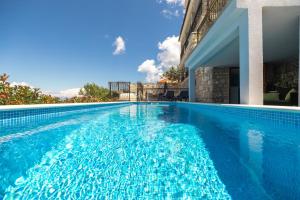 a swimming pool in front of a building at Holiday Home Dona Maria in Prigradica